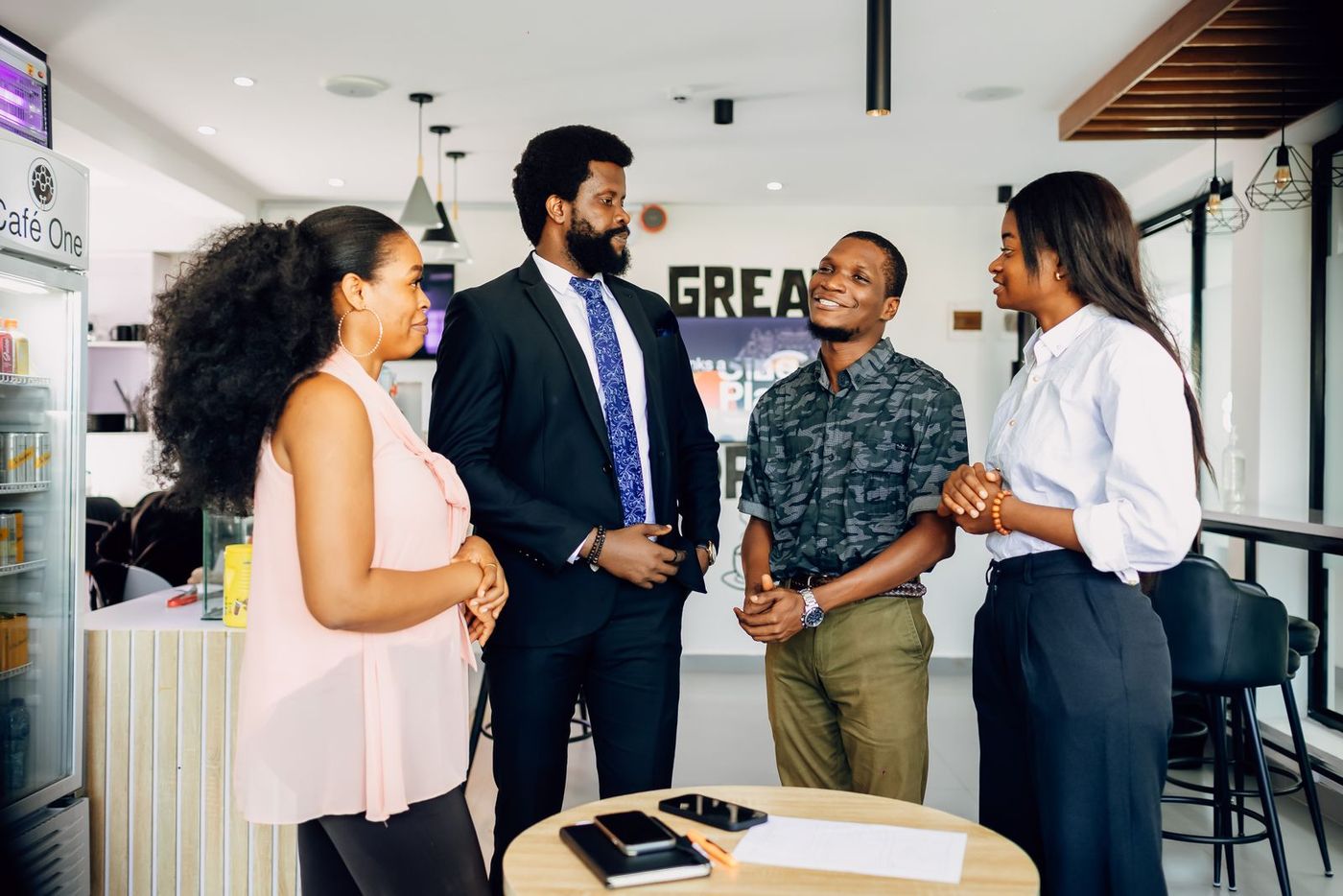Four colleagues talking together in a Lagos office