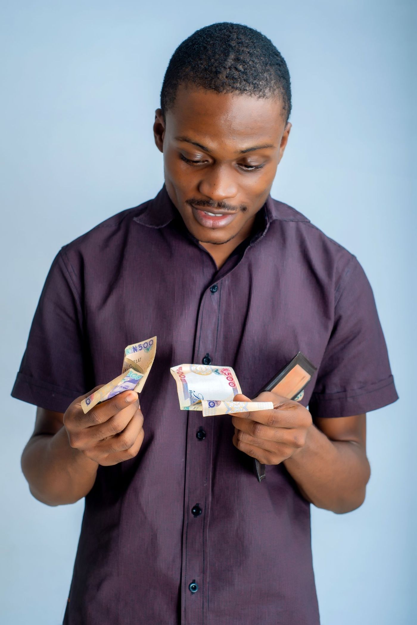 A man counting naira notes from his wallet